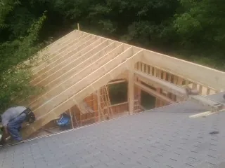 Framing a new roof addition that ties into an existing shingle roof in Girard
